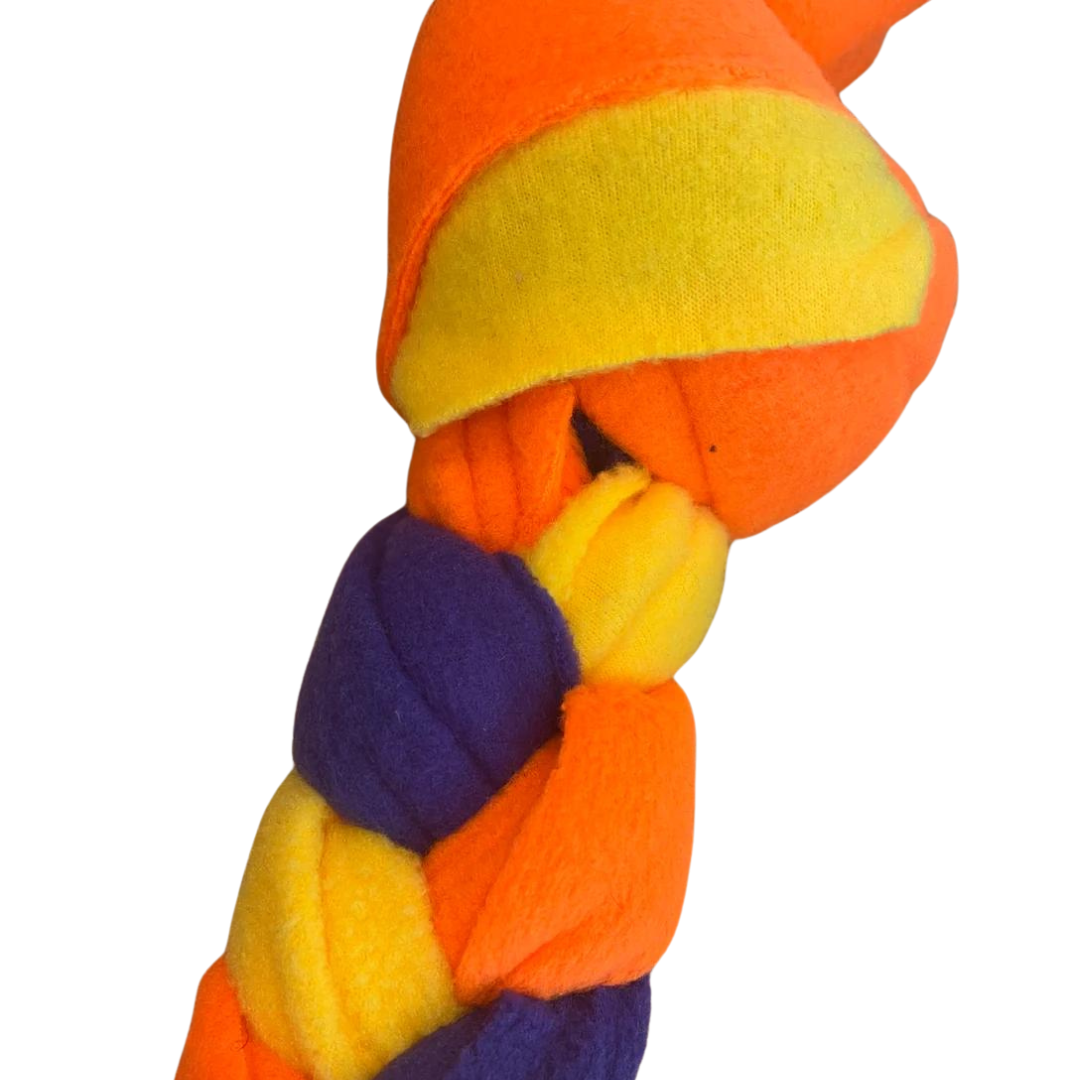 A close up of colourful handmade snuffle plait dog toy made from fleece.