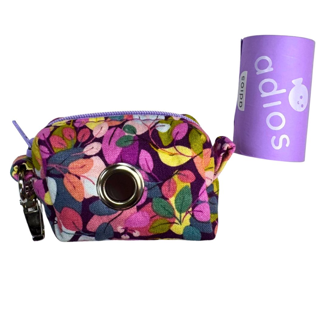 Side view of a floral-patterned poo bag holder with a roll of adios poo bags.