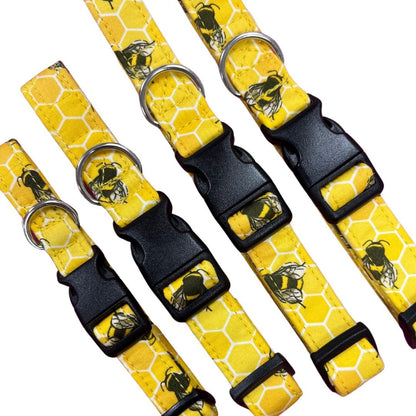 A collection of yellow dog collars with a bee hive print and plastic buckles.