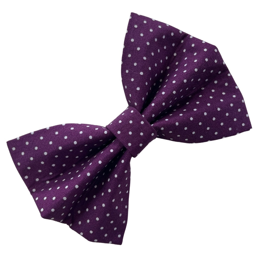 A purple dog bow tie with a blackberry spot pattern.