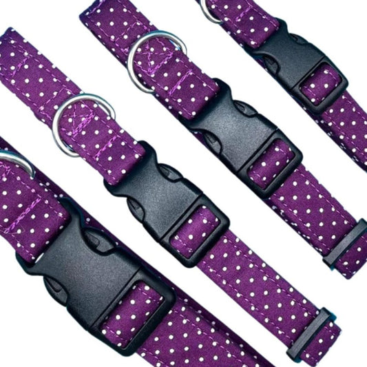 A collection of adjustable dog collars with a classic spot print, featuring a silver metal D-ring, plastic clip, and plastic tri-glide adjuster.