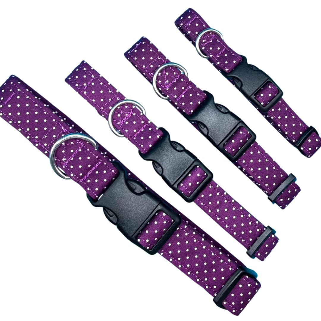 A collection of adjustable dog collars with a classic spot print, featuring a silver metal D-ring, plastic clip, and plastic tri-glide adjuster.