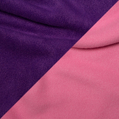 Close-up of a reversible handmade fleece dog snood with one half purple and the other half pink.