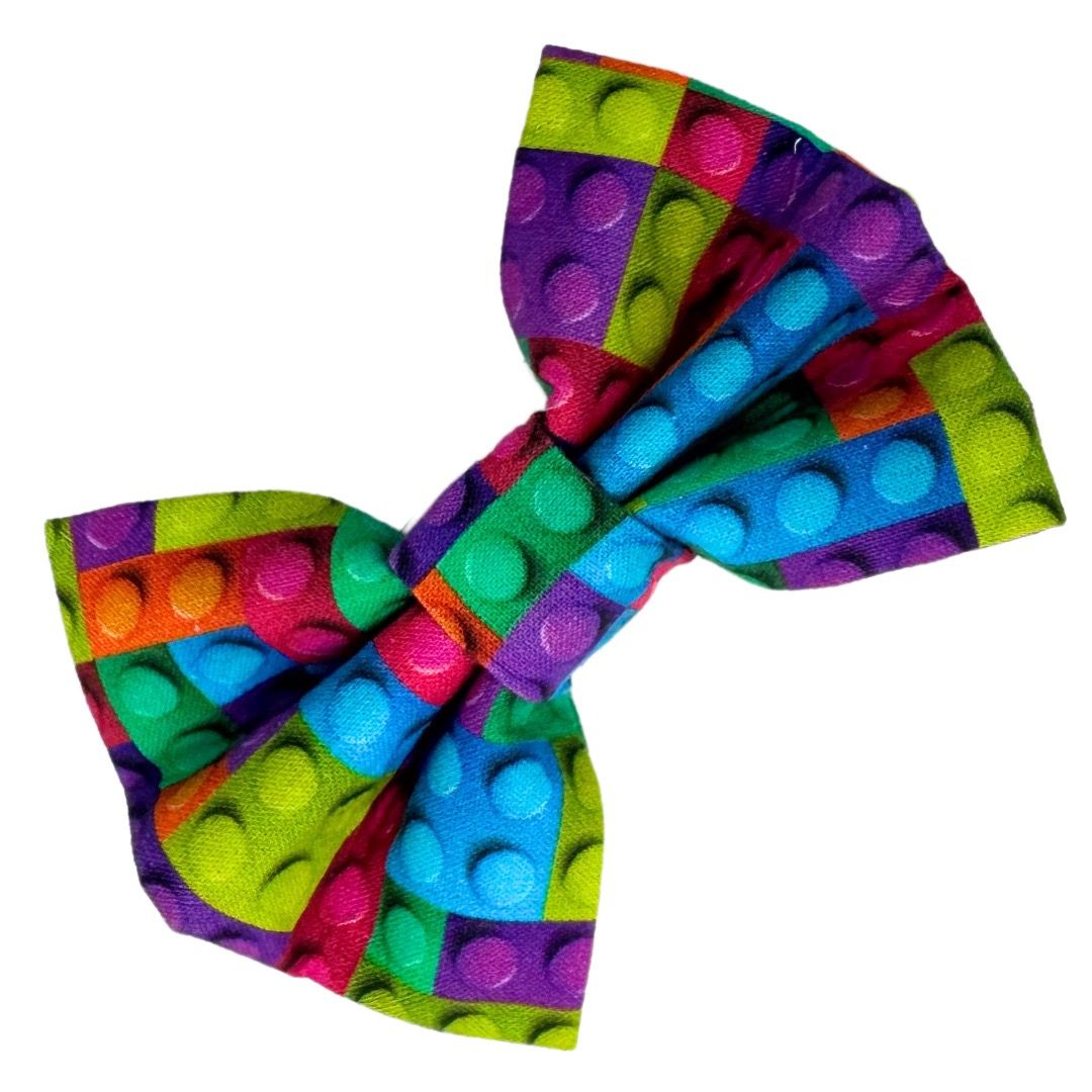 A colourful cotton dog bow with a building block pattern.