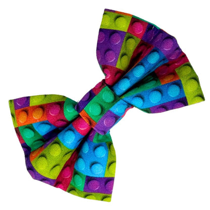 A colourful cotton dog bow with a building block pattern.