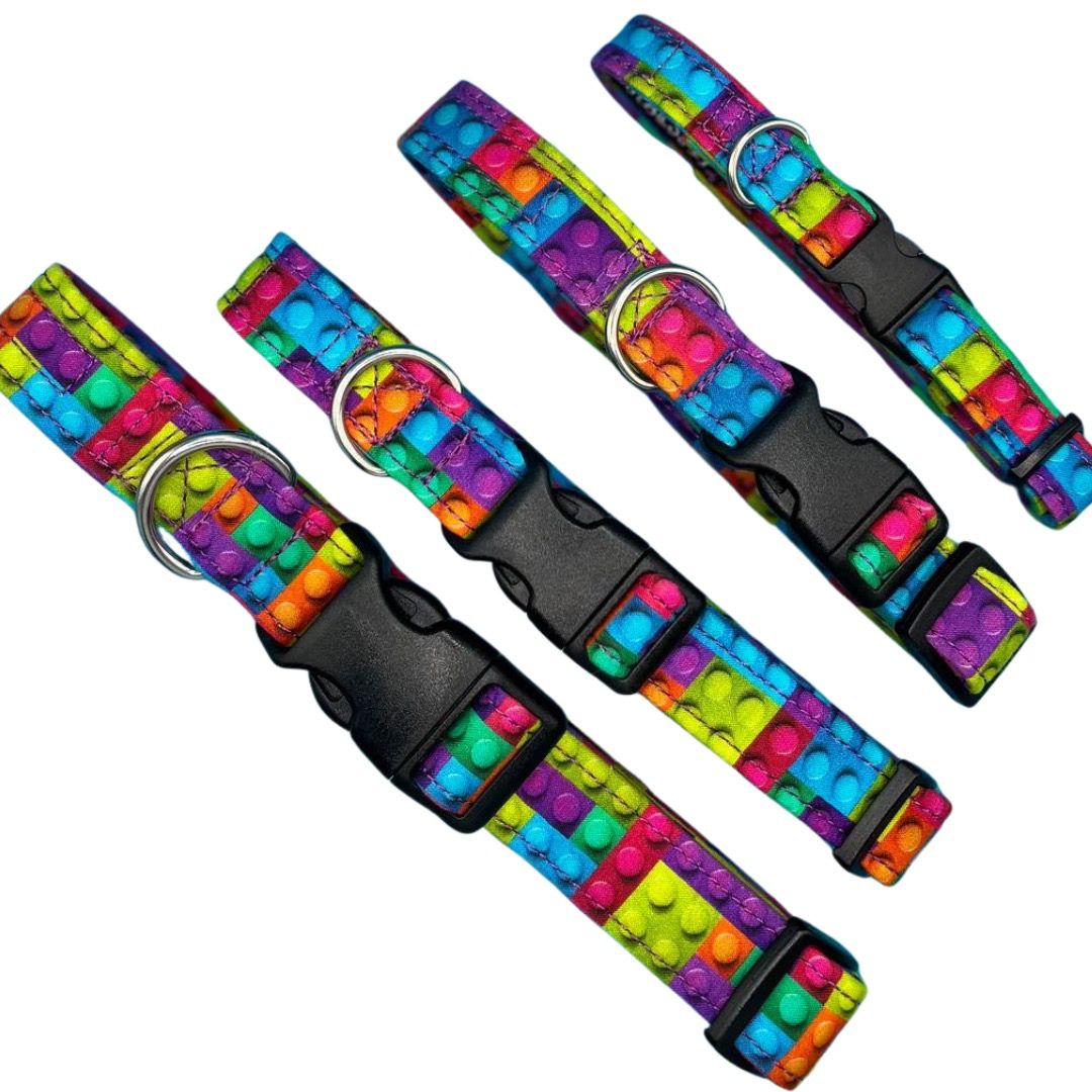 Four colourful dog collars with a building block pattern and a plastic clip.
