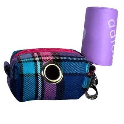 Plaid patterned poo bag holder with a circular opening and a roll of adios poo bags