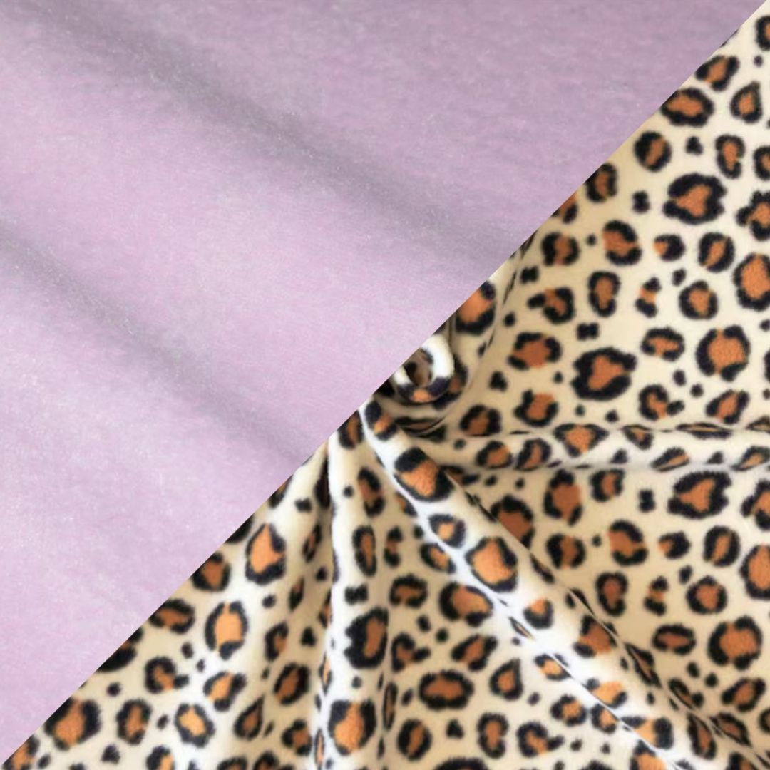 A reversible fleece dog snood with one side cheetah print and the other lilac colour.