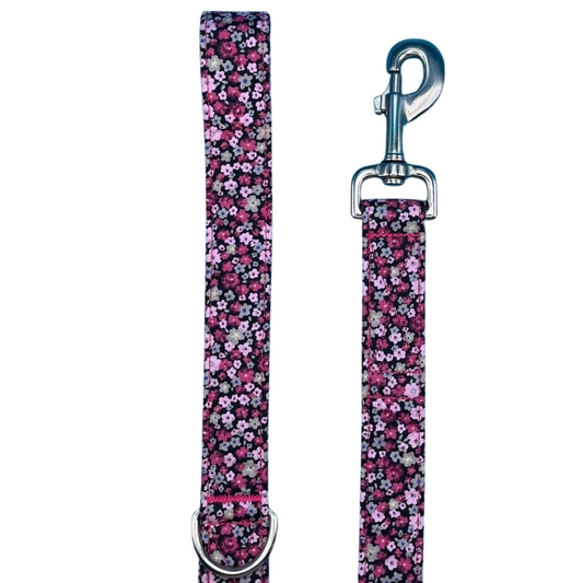 A dog lead with a cherry blossom floral pattern, featuring a large swivel clip and a metal D Ring.