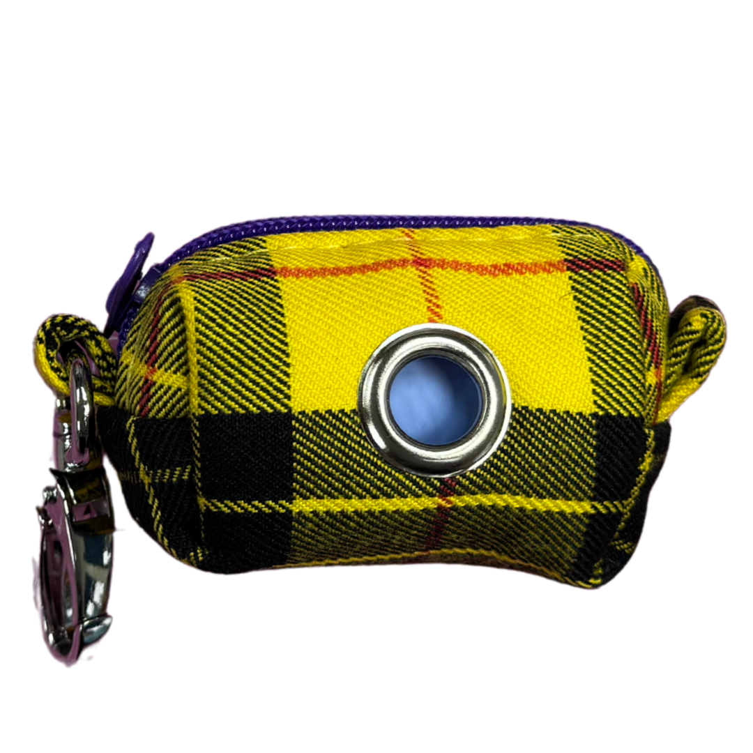 A Clueless Tartan fabric poo bag holder with a metal clip and a roll of zero waste, home compostable poo bags.
