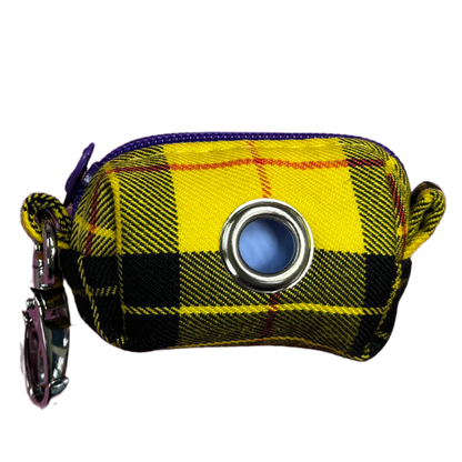 A Clueless Tartan fabric poo bag holder with a metal clip and a roll of zero waste, home compostable poo bags.
