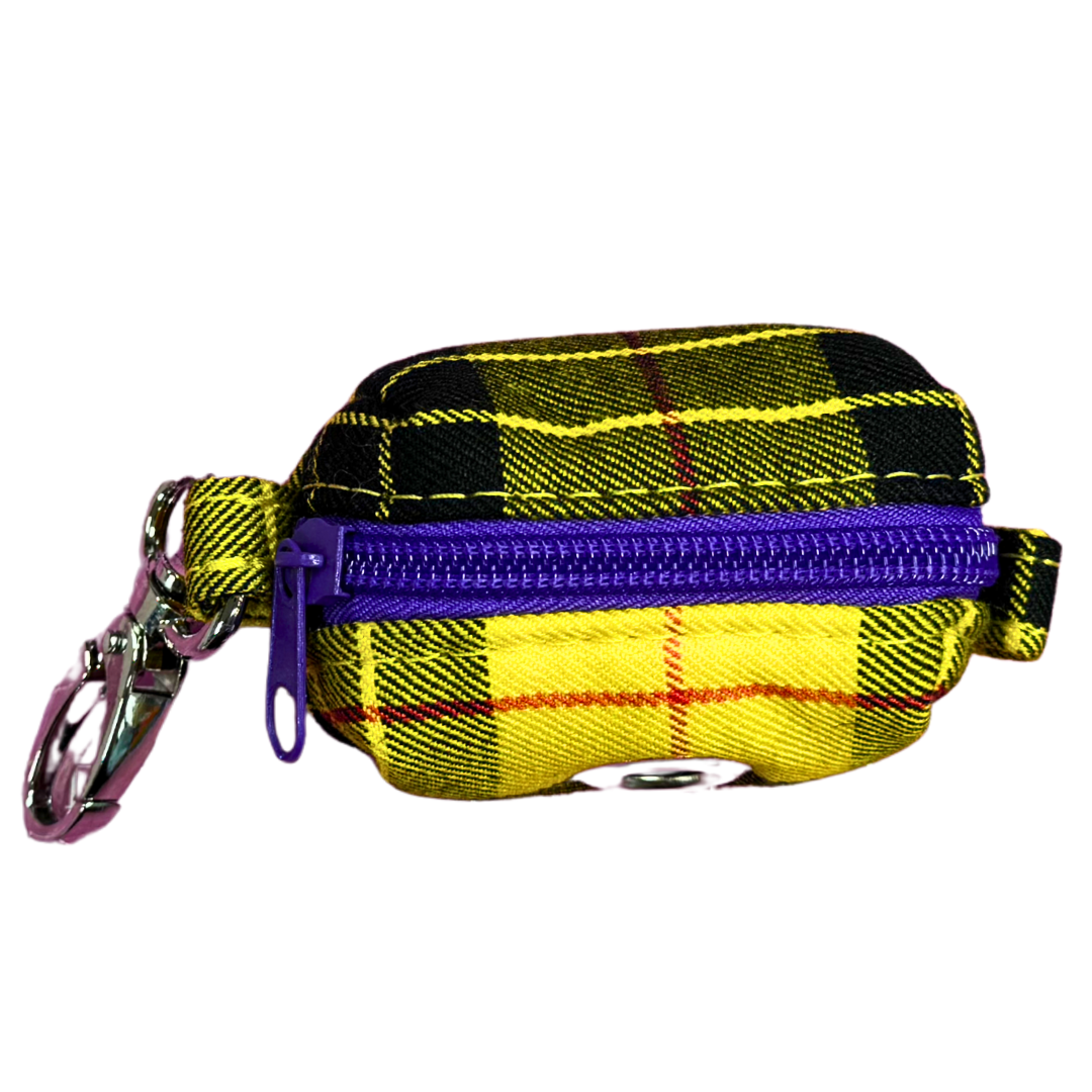 A yellow Clueless Tartan fabric poo bag holder with a metal clip.