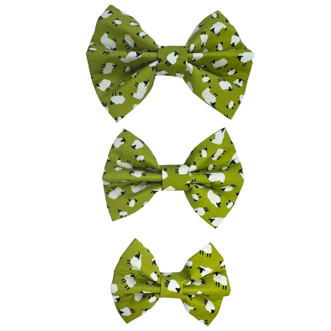 Three green dog bows with sheep pattern on a white background