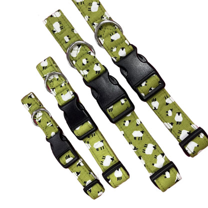 A collection of green dog collars with a white sheep print, featuring plastic buckles and metal D rings.