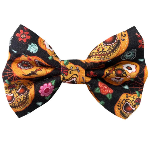 Colourful bow tie with a Halloween pumpkin themed design on a white background