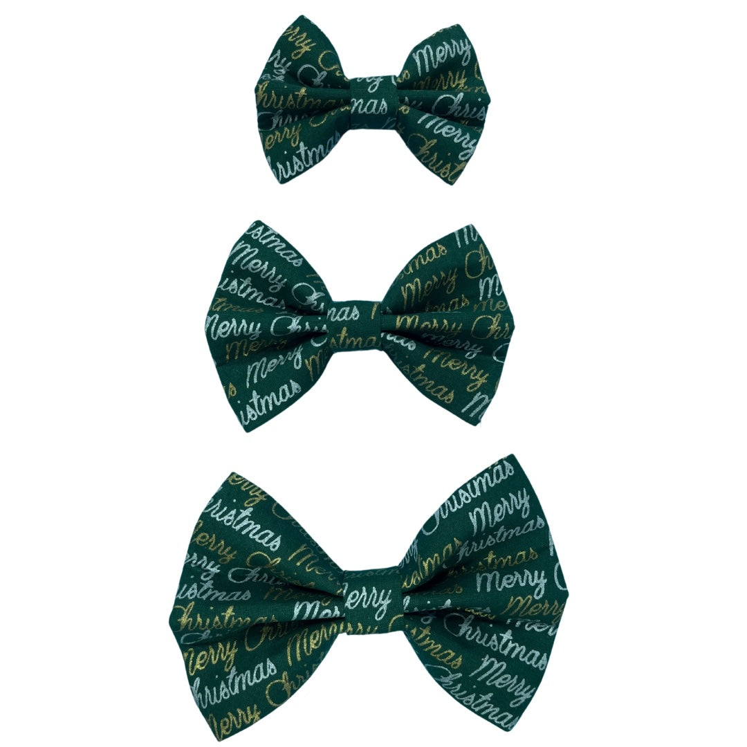 Three green bow ties in small, medium and large with 'Merry Christmas' text and gold and silver accents.