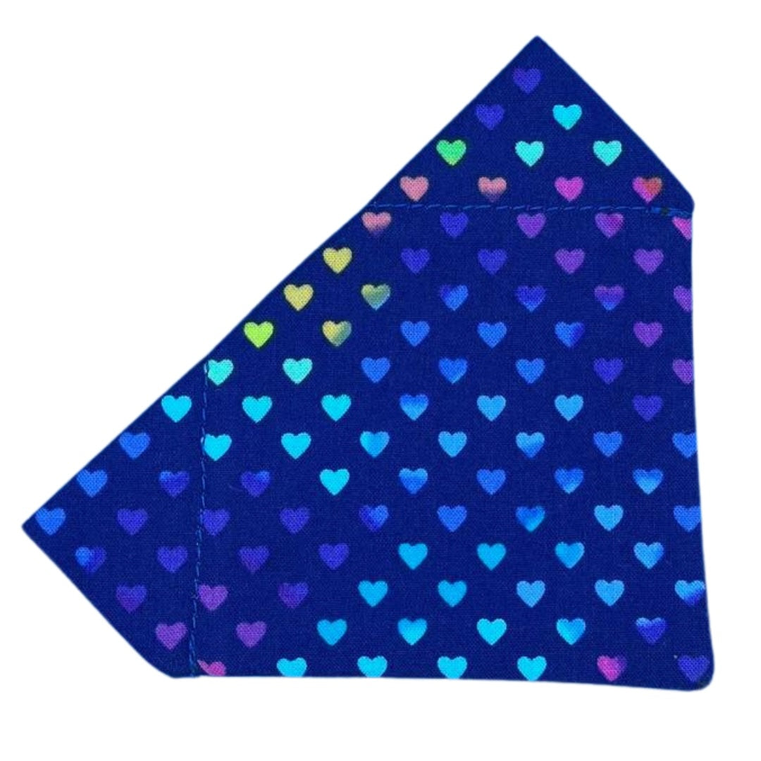 A blue bandana with a pattern of multicolored hearts, designed to be worn on a pet's collar.
