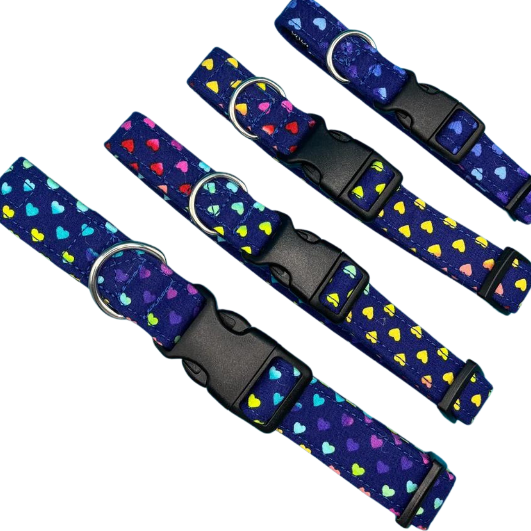 Four blue dog collars with a heart polka dot pattern, showing a plastic buckle and D-ring.
