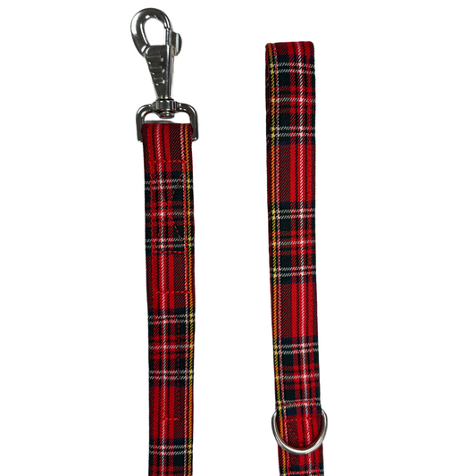A Red and Black Tartan Dog Lead with a strong webbing core and a poly viscose fabric covering, featuring a large swivel clip and metal D ring.