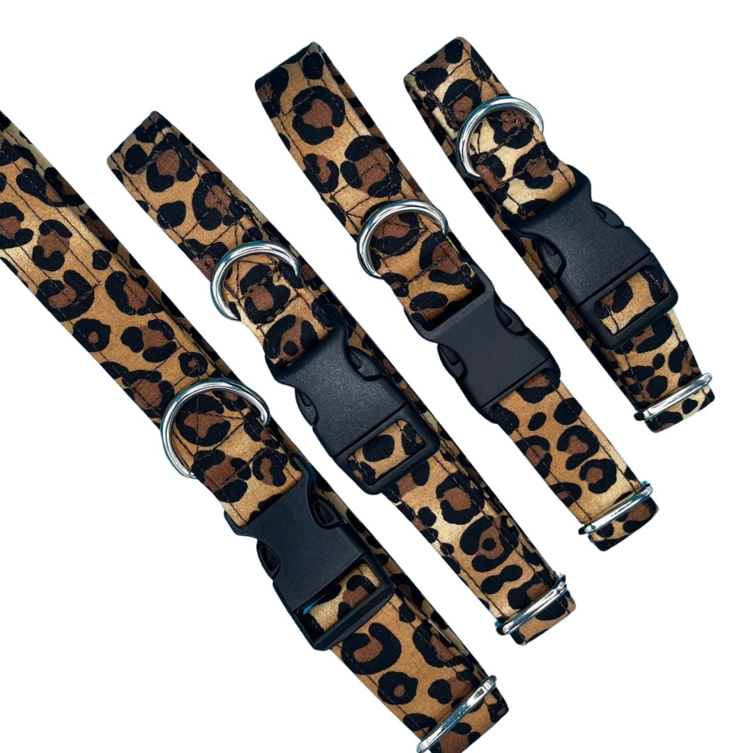 A collection of adjustable brown and black animal print dog collars with metal D rings and plastic buckles. 
