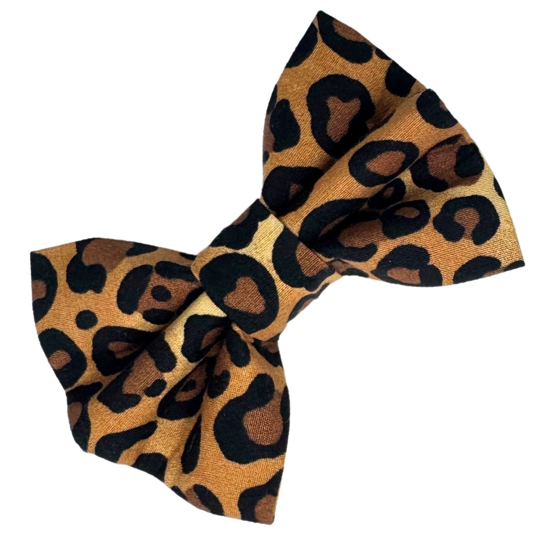 A brown and black animal print fabric dog bow.