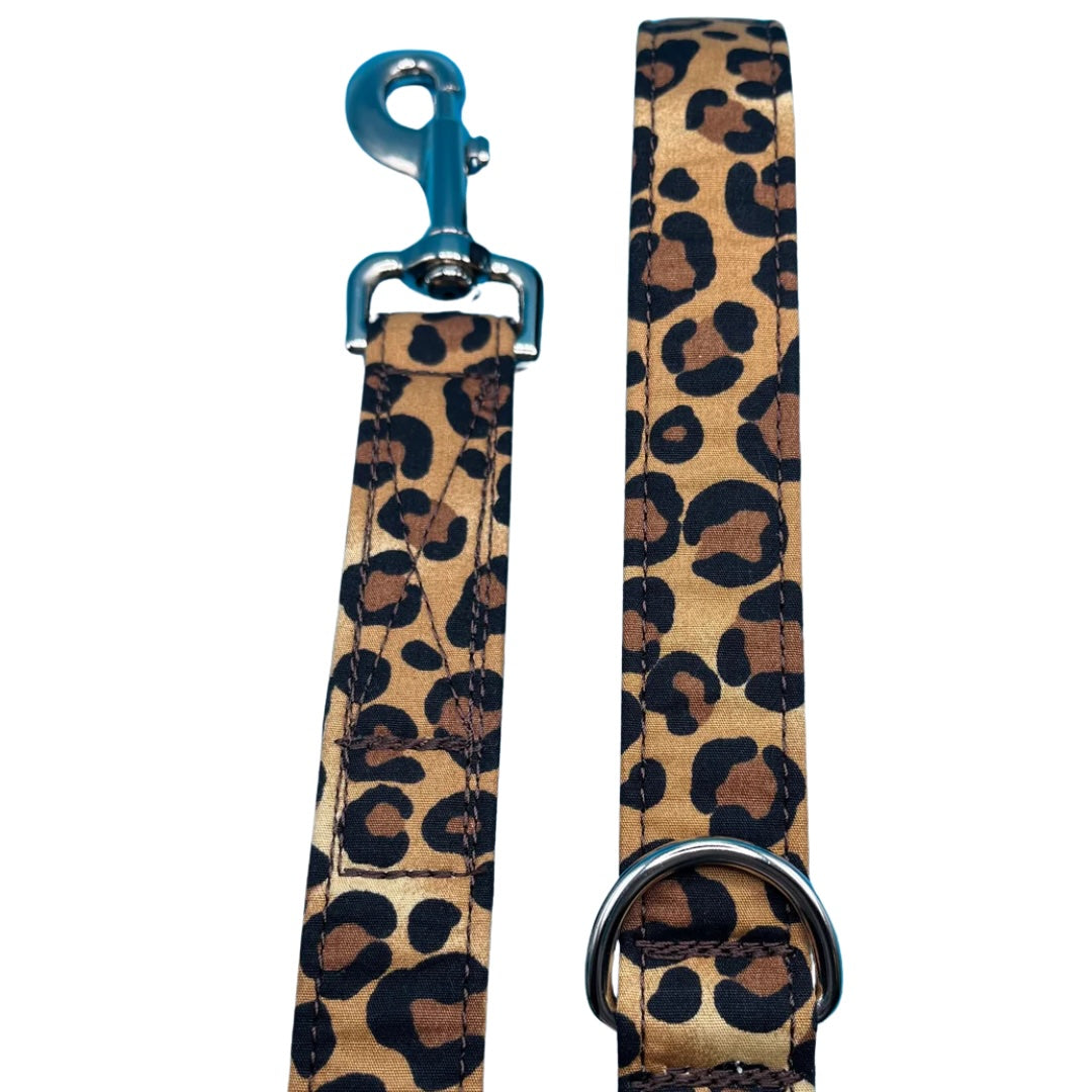 A handmade brown and black leopard print dog lead with silver metal hardware and a blue swivel clip.