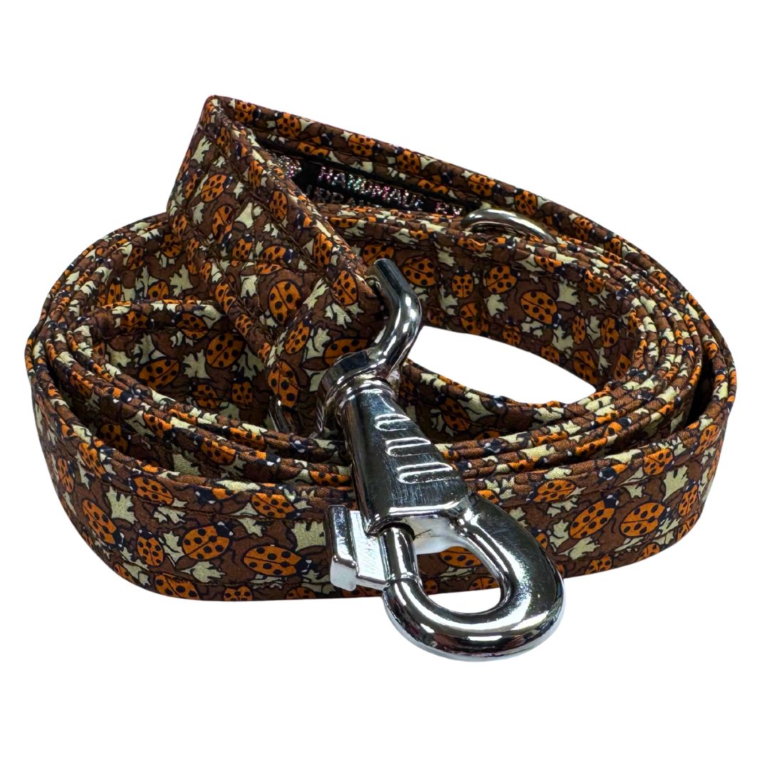 Close up of the coiled dog leash with a ladybird pattern showing the clip