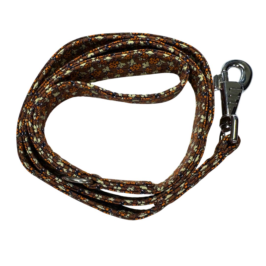 Top view of a coiled dog leash with a ladybird pattern showing the clip