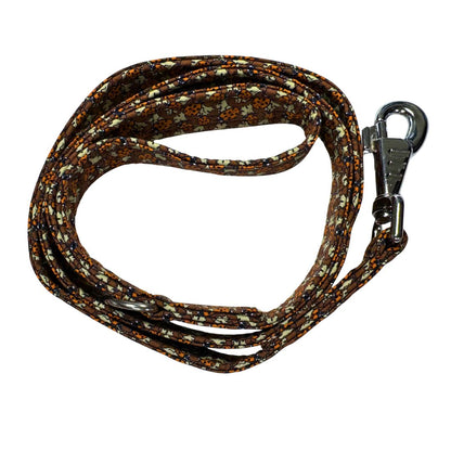 Top view of a coiled dog leash with a ladybird pattern showing the clip