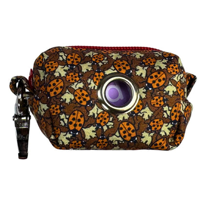 Side view of a Ladybird patterned poo bag holder.