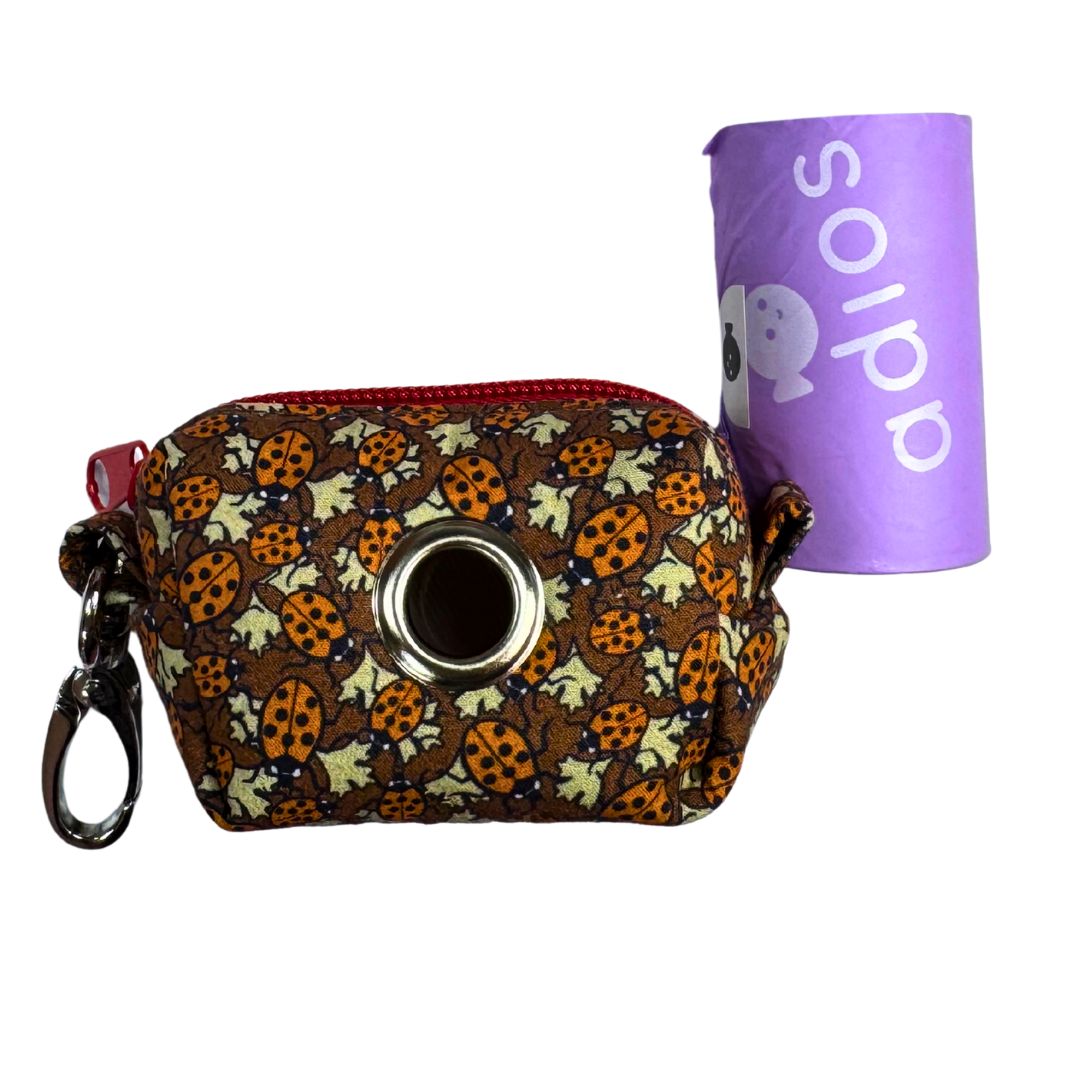 Ladybird patterned poo bag holder with a roll of adios poo bags.