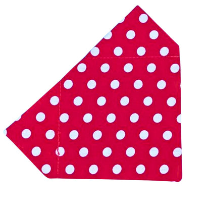 A red bandana with white polka dots designed to slip on a collar for dogs.