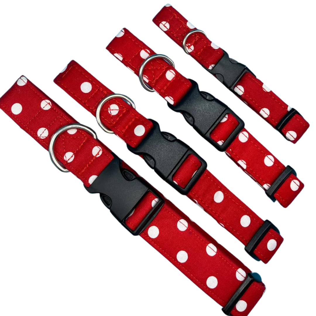 A collection of red dog collars with white polka dots and black plastic buckles.