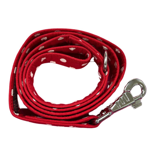 A coiled red dog lead with white polka dots and a metal clasp.