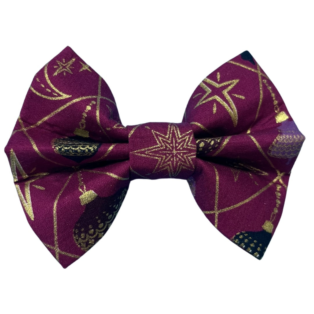 Handmade festive bow with baubles and gold detail on a rich purple background