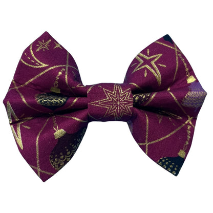 Handmade festive bow with baubles and gold detail on a rich purple background
