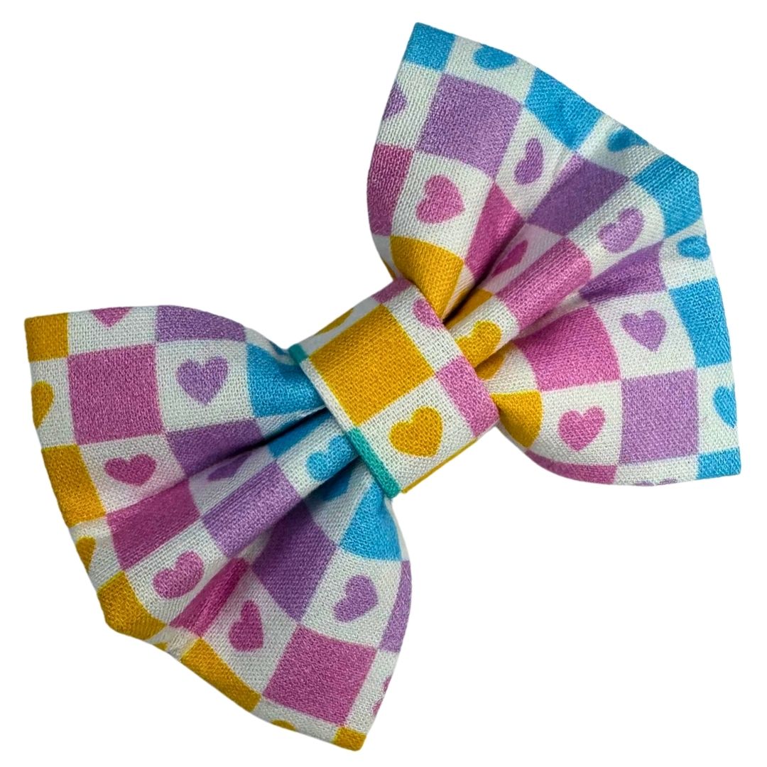 Colourful checkered bow with heart patterns
