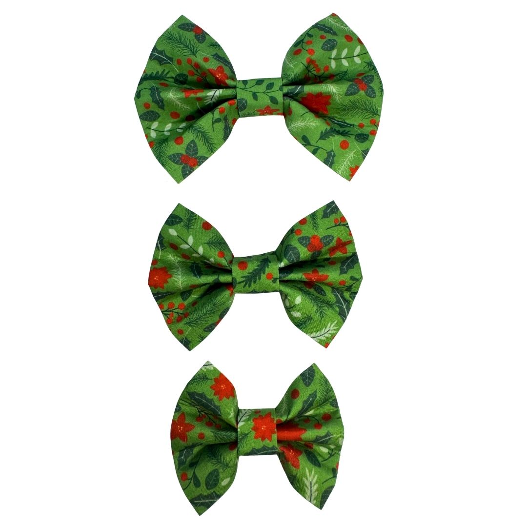 Three green pet bow ties with red floral patterns