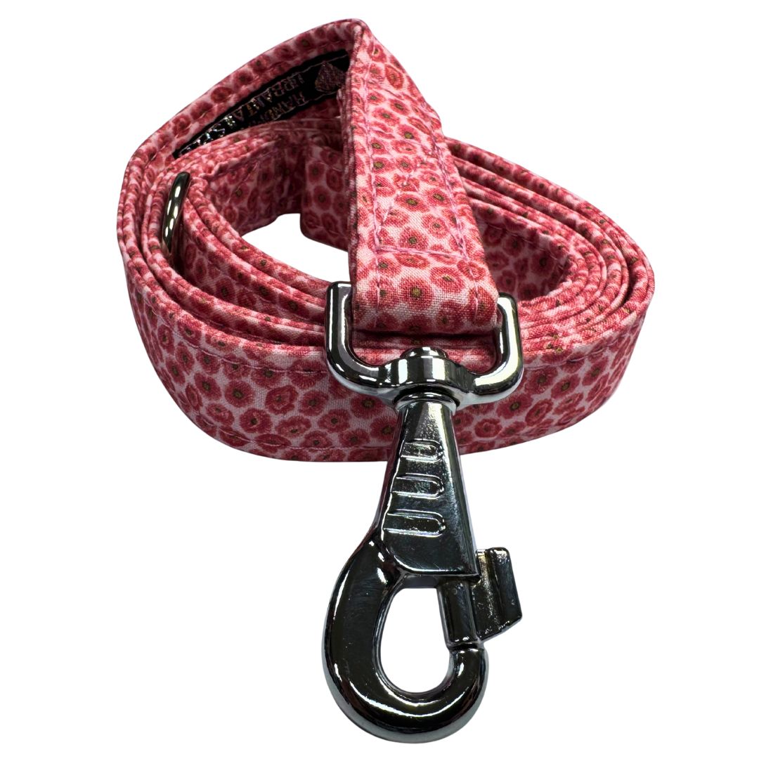 Pink floral patterned dog leash with a silver clasp on a white background