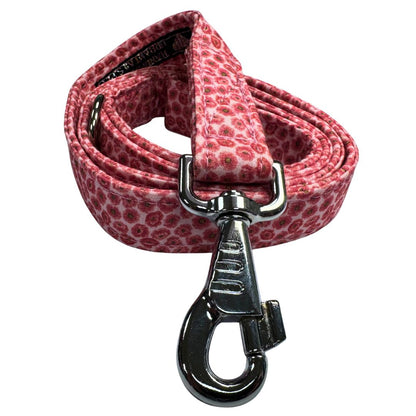 Pink floral patterned dog leash with a silver clasp on a white background