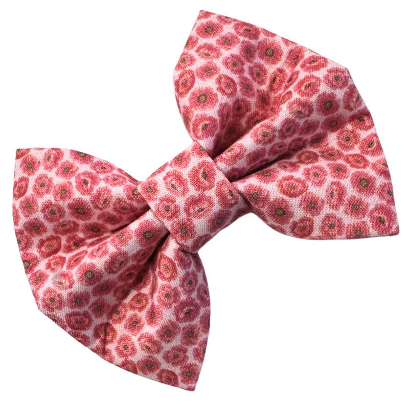 Pink floral patterned bow on a white background