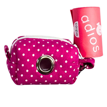 Pink polka dot dog poo bag dispenser with  a roll of adios poo bags