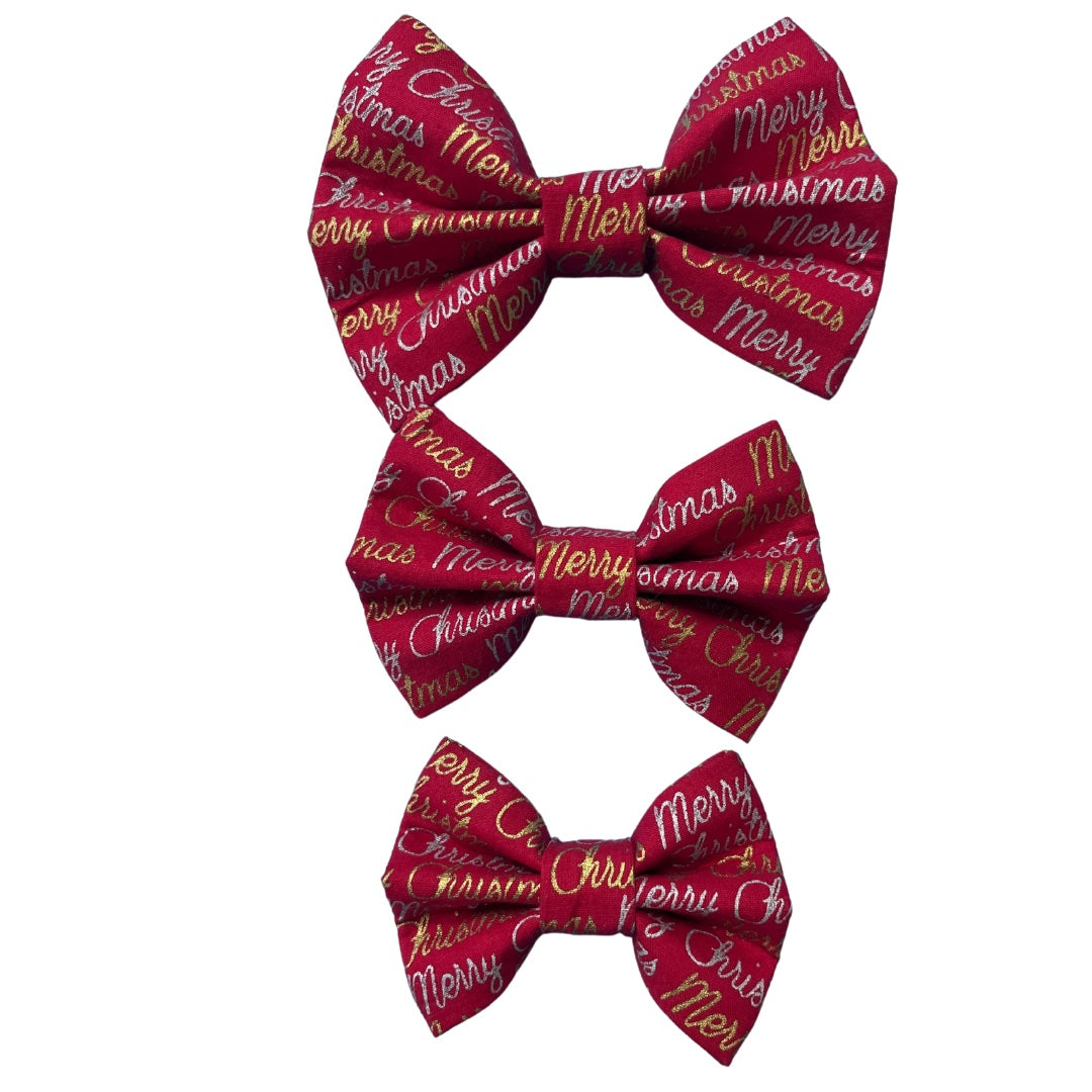 Three red bow ties in small medium and large with 'Merry Christmas' text and gold and silver accents.