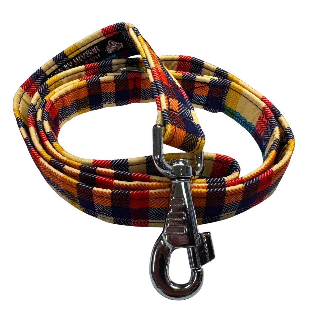 A  close up of a handmade Richmond Tartan Fabric orange, cream, navy dog leash with metal clasp