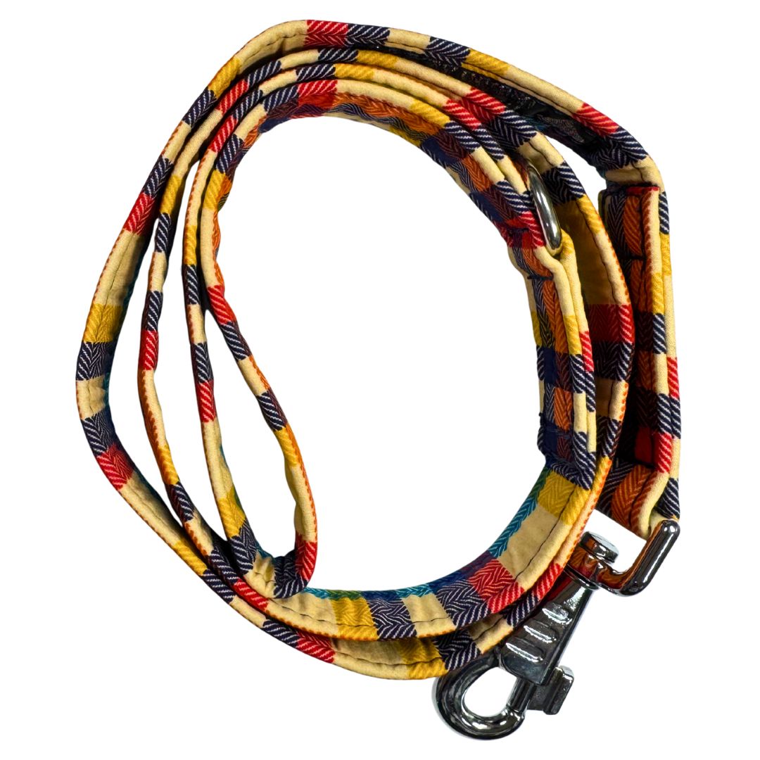 Top view of a handmade Richmond Tartan Fabric orange, cream, navy dog leash with metal clasp