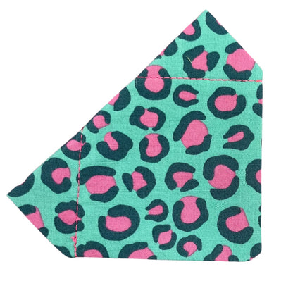 A cotton Dog Bandana with a  leopard print pattern in pink and teal designed to slip onto a collar.