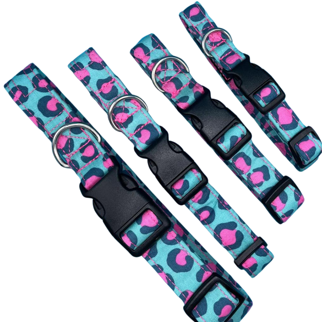 Four adjustable dog collars with a leopard print pattern in pink and green, with plastic buckles, and a metal D-ring for lead attachment.