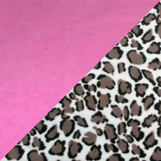 A reversible fleece dog snood with one side snow leopard print and the other pink