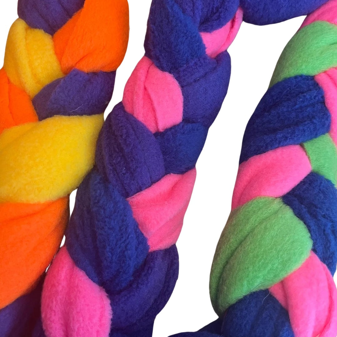 A colourful handmade snuffle plait dog toy made from fleece.