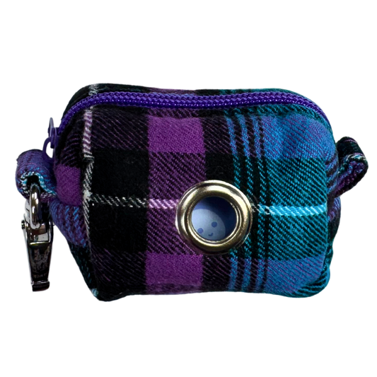 Plaid patterned poo bag holder with a purple zipper.